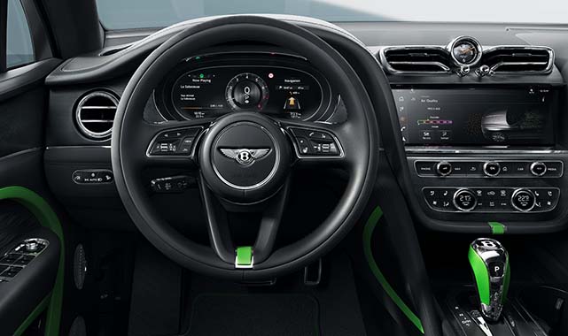 Interior cockpit view of the Bentley Bentaygas, leather-wrapped steering wheel, digital instrument cluster, and central infotainment system with green accents.