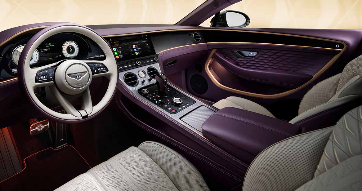 Luxurious Bentley Continental GT interior featuring cream leather seats, purple leather trim, and a high-tech center console with wood and metal accents.
