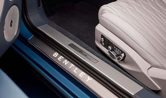 Illuminated Bentley-branded door sill and quilted leather seat with electronic adjustment controls inside a Bentley Continental GTC.