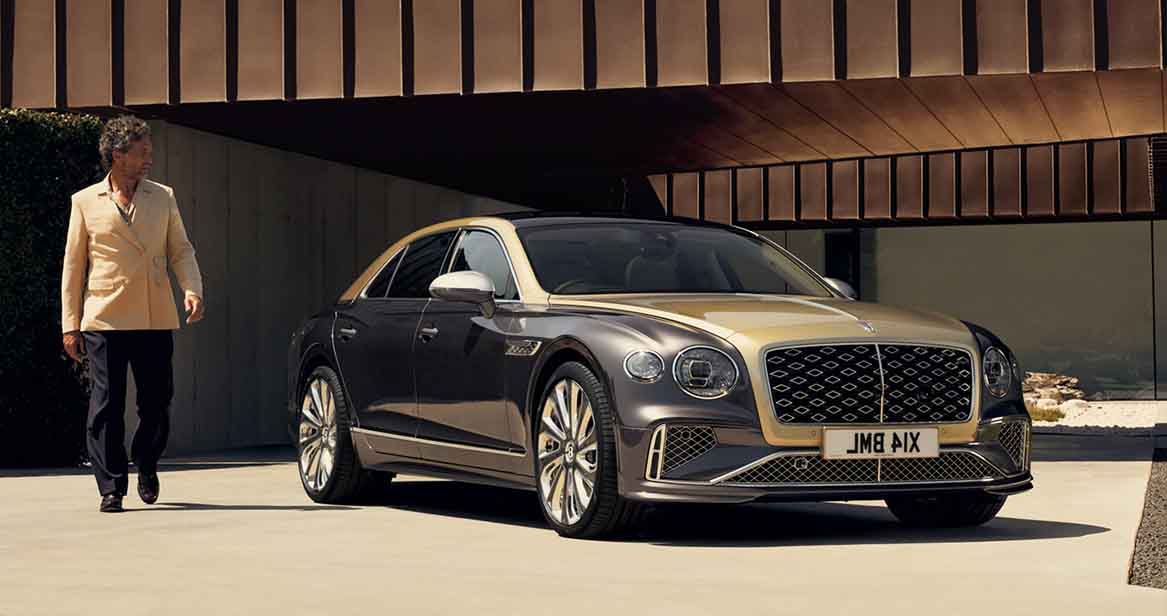 Bentley Flying Spur Mulliner parked under a modern architectural overhang.