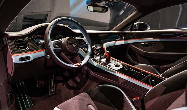 Luxurious interior of the 2026 Bentley Supersports showcasing dual-tone steering wheel, carbon fiber accents, and high-tech control layout.