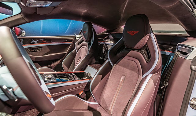 Front racing-inspired bucket seats in the 2026 Bentley Supersports finished in premium Alcantara with embroidered red Bentley emblem.