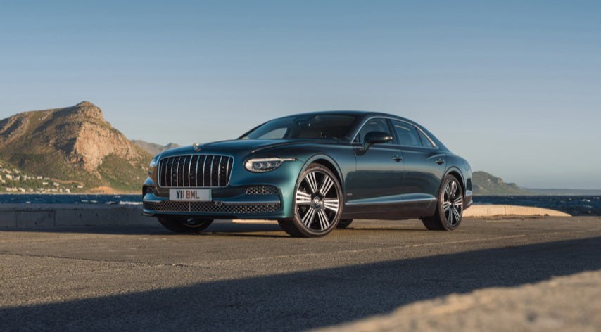 2027 Bentley Flying Spur Azure in Dark Teal parked on a coastal road